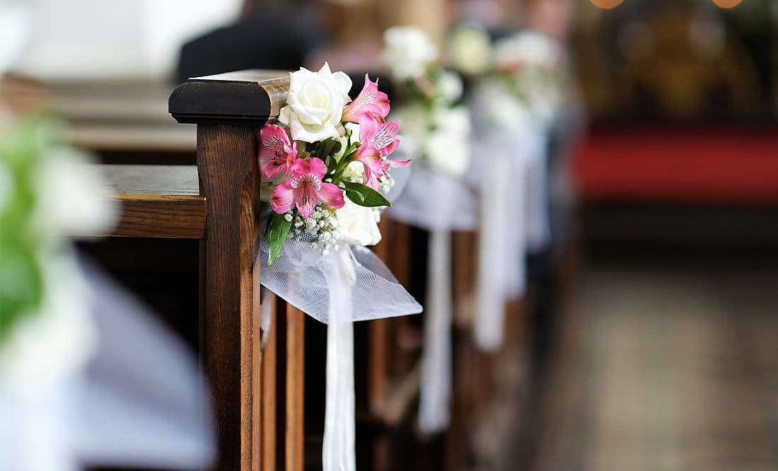 Kirchenpulte seitlich geschmückt mit festlichen Blumenarrangements